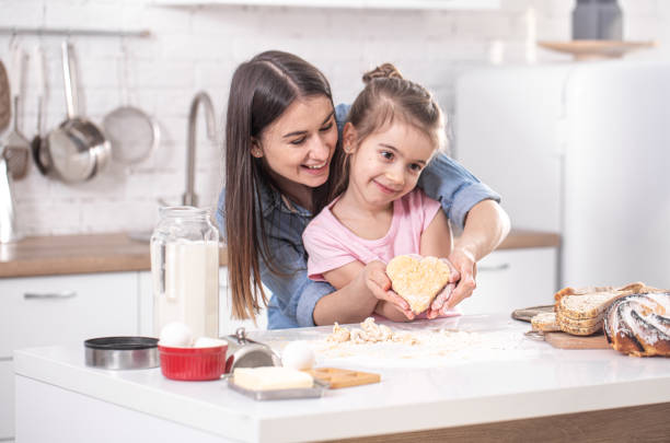 istock Mom and daughter prepare pastries in the kitchen. 1211339743