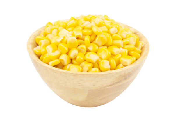 istock Canned corn seeds in wooden bowl isolated on white 1211340066