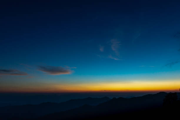 Horizon sky with silhouette mountain before sunrise stock photo