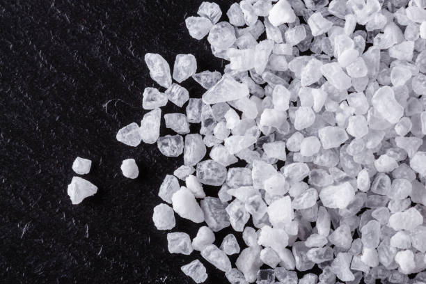 istock coarse sea salt on a dark stone background 1211341803