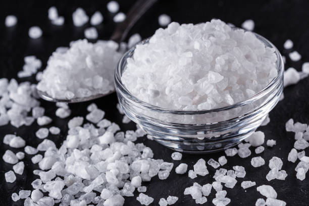 istock coarse sea salt on a dark stone background 1211342174