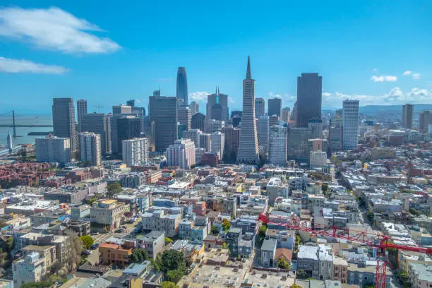 Photo of San Francisco skyline with crane in foreground and blue sky