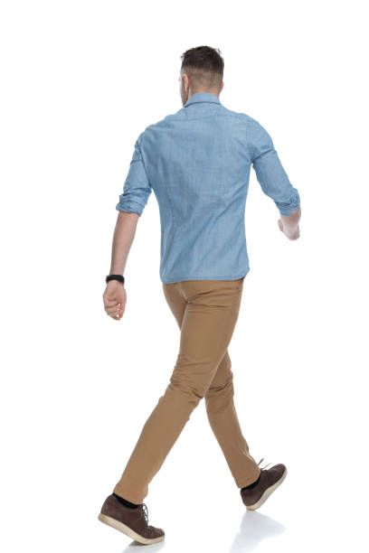 istock Rear view of eager casual man walking 1211344845