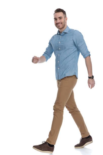 istock Side view of handsome casual man smiling and stepping 1211345082