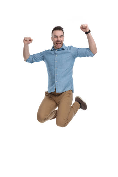 istock Cheerful casual man celebrating and shouting while jumping 1211345139