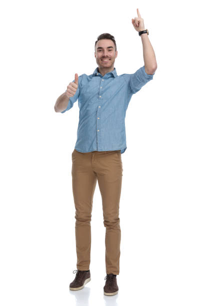 istock Positive casual man pointing up and gesturing ok 1211345247