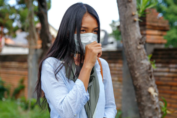 istock Asian woman coughing during covid 19 outbreak 1211345533