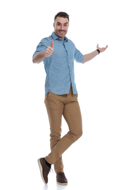 istock Happy casual man presenting and giving thumbs up 1211345636