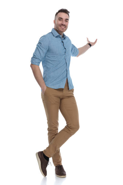 istock Charming casual man presenting with his hand in his pocket 1211346203