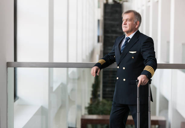 istock Experienced Senior pilot waiting at the airport lobby for flight 1211346235