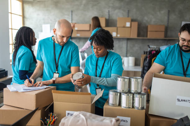 istock Group of friends doing charity work in charitable foundation 1211346340