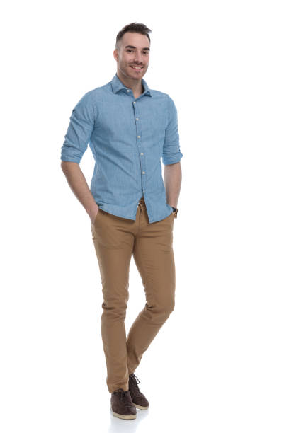 istock Positive casual man smiling with both hand in his pockets 1211346360
