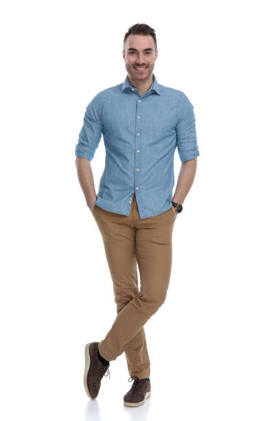 istock Happy casual man smiling with both hand in his pockets 1211346380