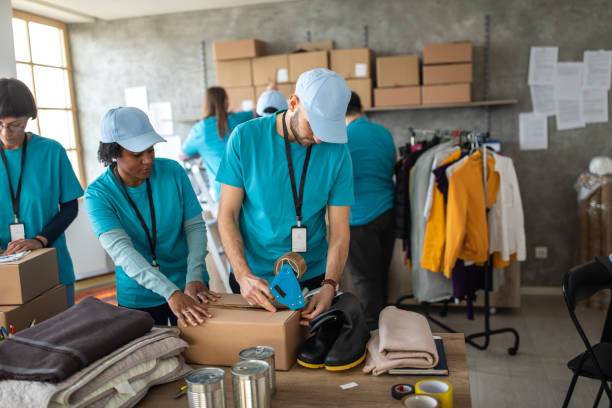 istock Group of multi-ethnic people packing donation boxes at charitable foundation 1211346438