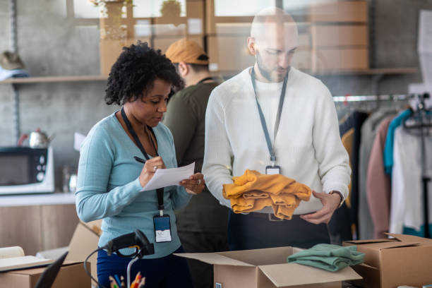 istock Workers packing clothes product for online business at e-commerce office 1211346492