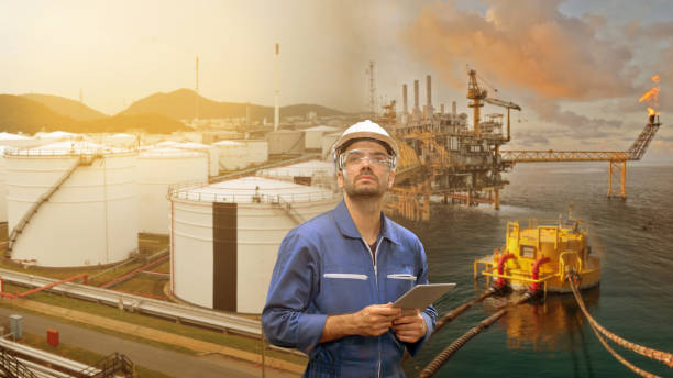 istock Caucasian man engineer staff worker with tablet in hand and refinery background concept. 1211346548