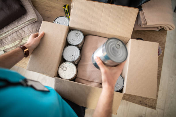 istock Volunteer packing donations during coronavirus pandemic 1211346617