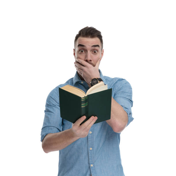 istock Amazed casual reading book and gasping 1211346683