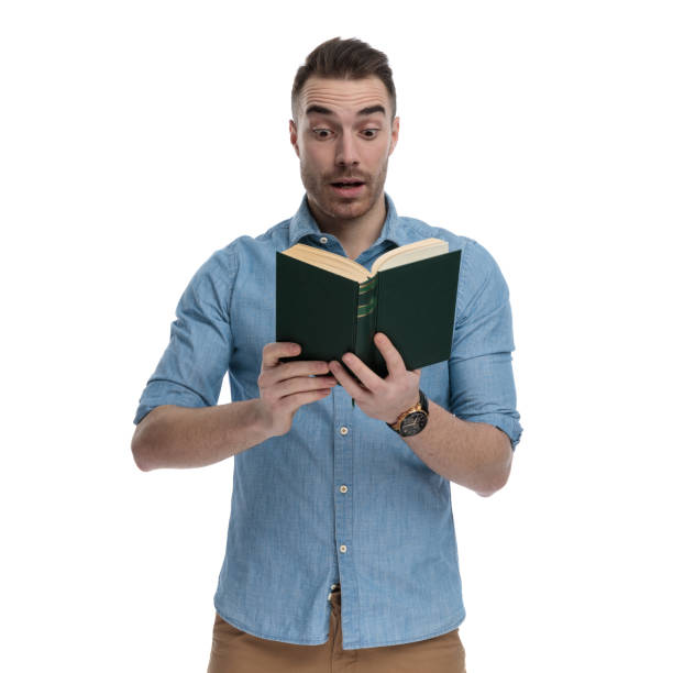 istock Surprised casual reading book and gasping 1211346705