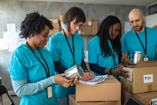 istock Volunteers preparing donation boxes for delivery, at a charitable foundation 1211346753