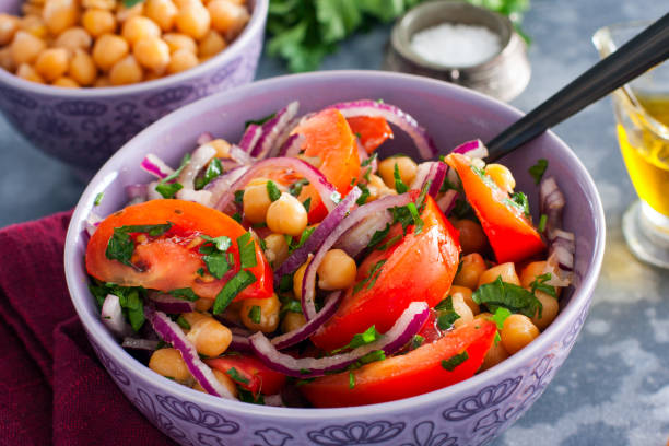 istock Salad with tomatoes, chickpeas and red onions, selective focus 1211347057