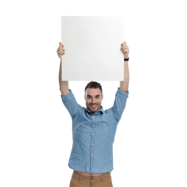 istock Proud casual man holding empty billboard above his head 1211347971