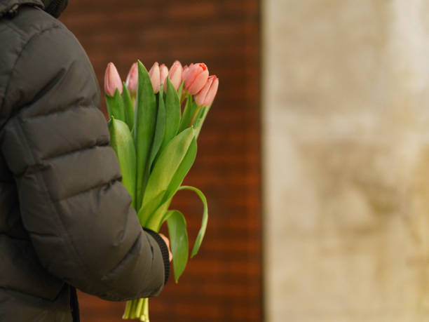 istock Woman with pink tulips. 1211348589