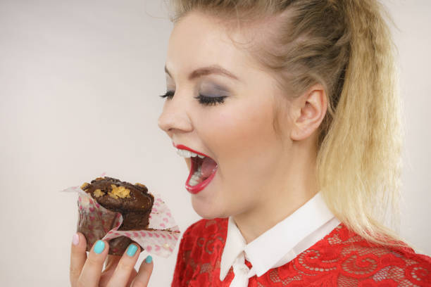 istock Attractive woman holds cake in hand 1211350537