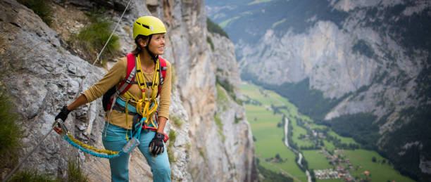 istock Pretty, female climber on a via ferrata 1211351571