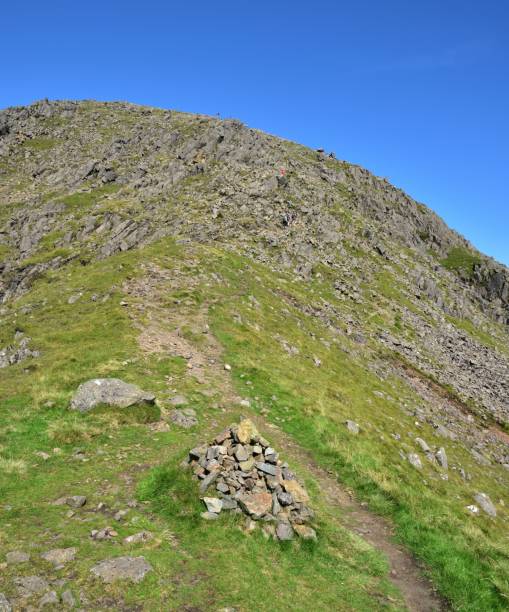 istock Climbers on the track and summit of Scoat Fell 1211351835