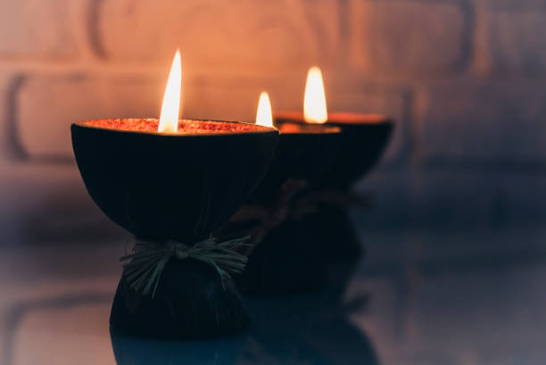 istock Burning spa aroma candles in coconut shell on a glass white table, cozy home interior 1211352125