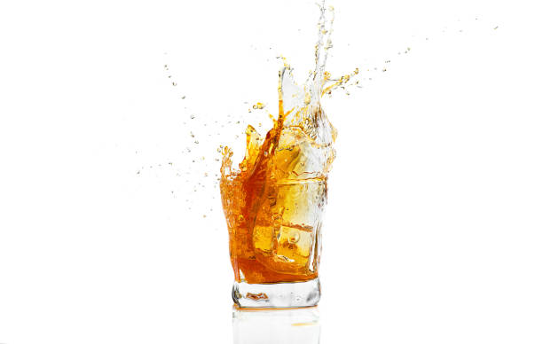 istock Whiskey with splash on white background, brandy in a glass 1211352158