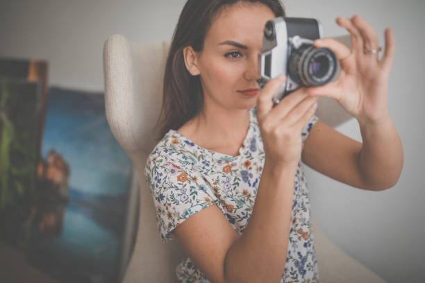 istock Pretty, young female photographer in her studio 1211352269