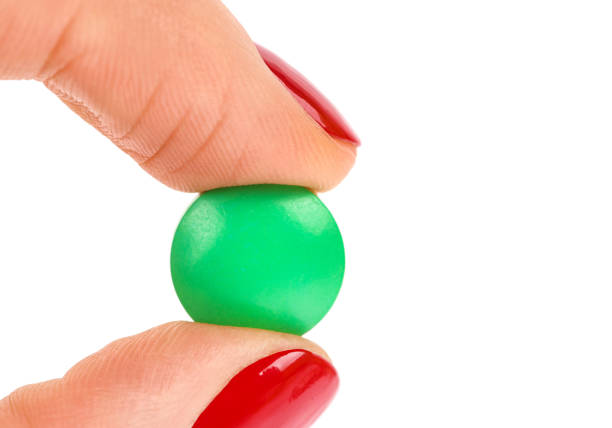 istock Pills in woman hand isolated on white background 1211352508