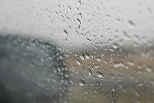 istock car rearview mirror behind glass wet from rain 1211354058