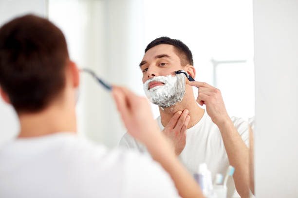 istock man shaving beard with razor blade at bathroom 1211354992