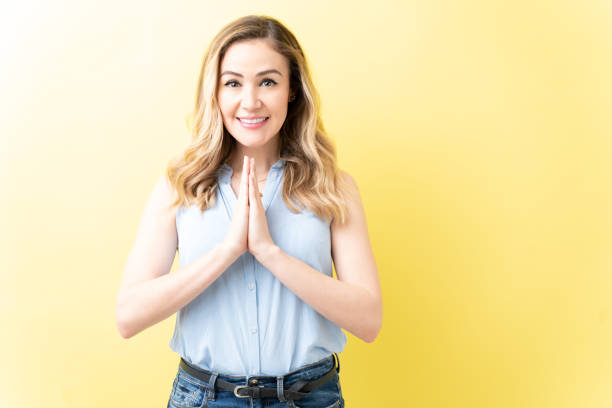 istock Beautiful Woman Is Joining Hands Over Colored Background 1211355023
