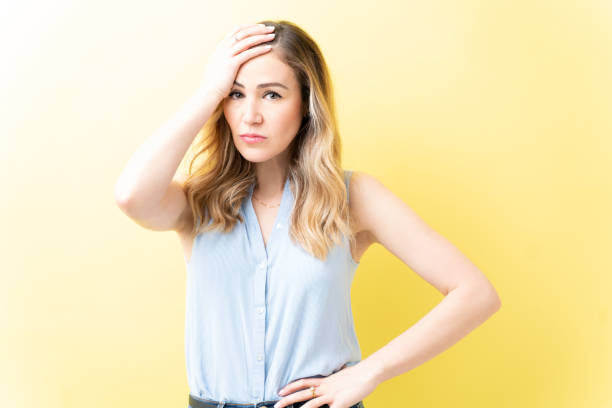istock Irritated Woman Is Standing With Head In Hand 1211355372