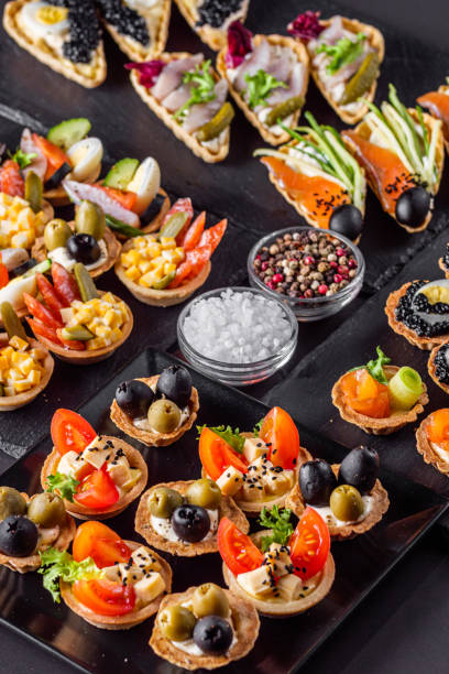 istock delicious snack tartlets on dark stone background 1211357064