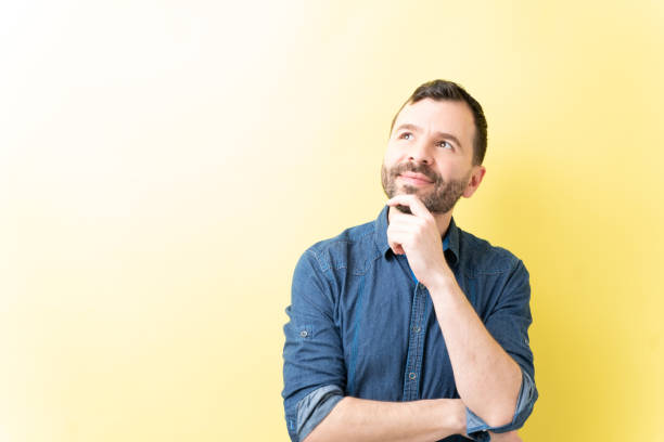 istock Thoughtful Adult Man With Hand On Chin 1211357217