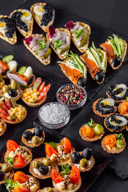 istock delicious snack tartlets on dark stone background 1211357786