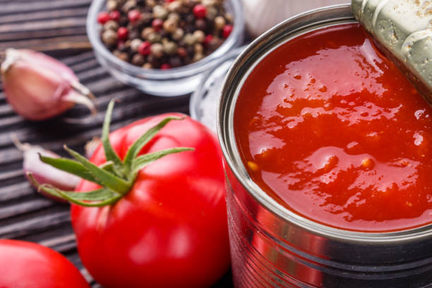 istock juicy canned tomatoes on wooden rustic background 1211358380