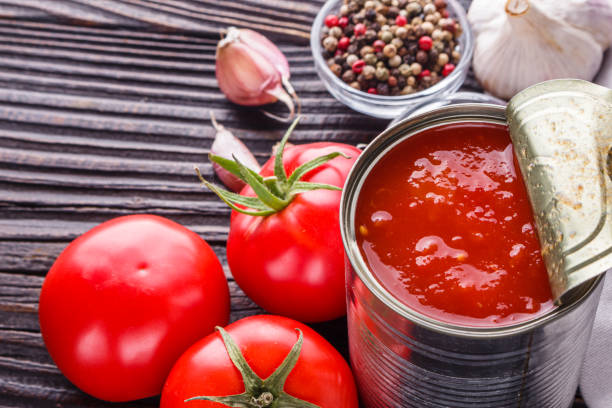 istock juicy canned tomatoes on wooden rustic background 1211358446