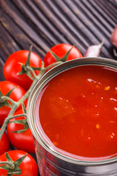 istock juicy canned tomatoes on wooden rustic background 1211359181