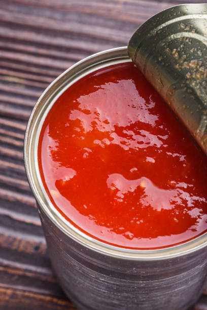 istock juicy canned tomatoes on wooden rustic background 1211359200