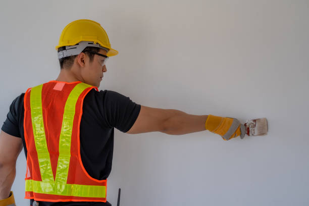 istock Workers paint the walls with paint brushes. 1211359332