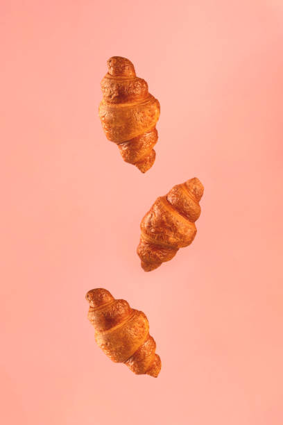 istock Croissants flying on pink background. 1211359441