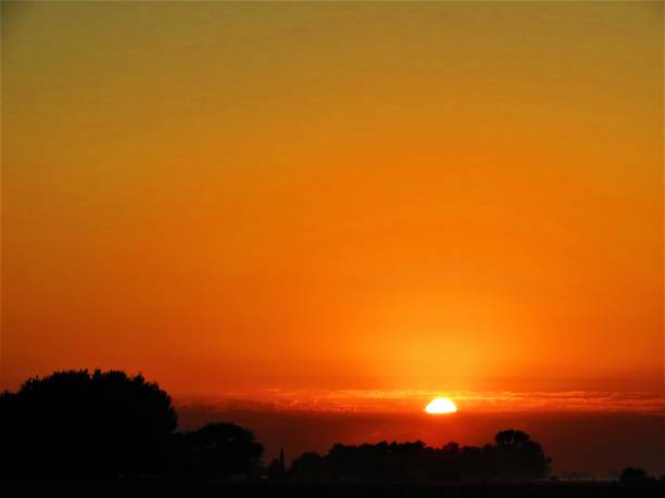 istock Beautiful sunrise landscape with orange sky above it. 1211361079