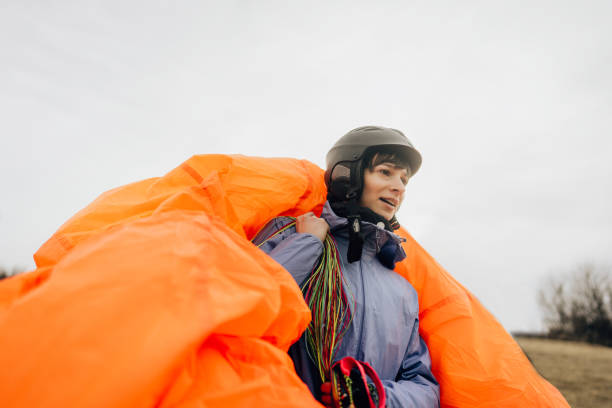 Photo of a woman carrying her parachute