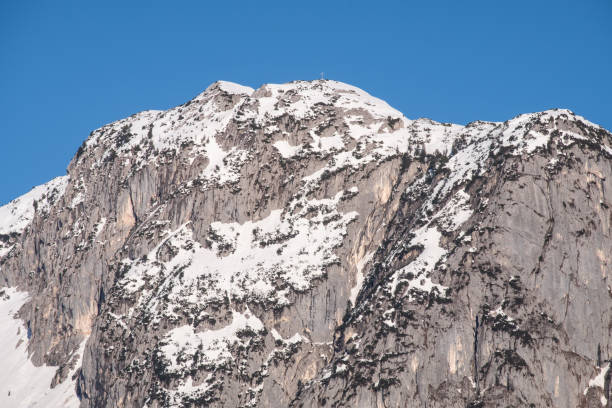 istock Snowy mountain peak Backenstein with summit cross on winter day 1211363223